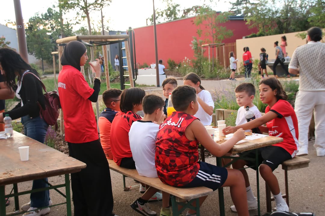 Les familles et les enfants partagent un moment autour des tables